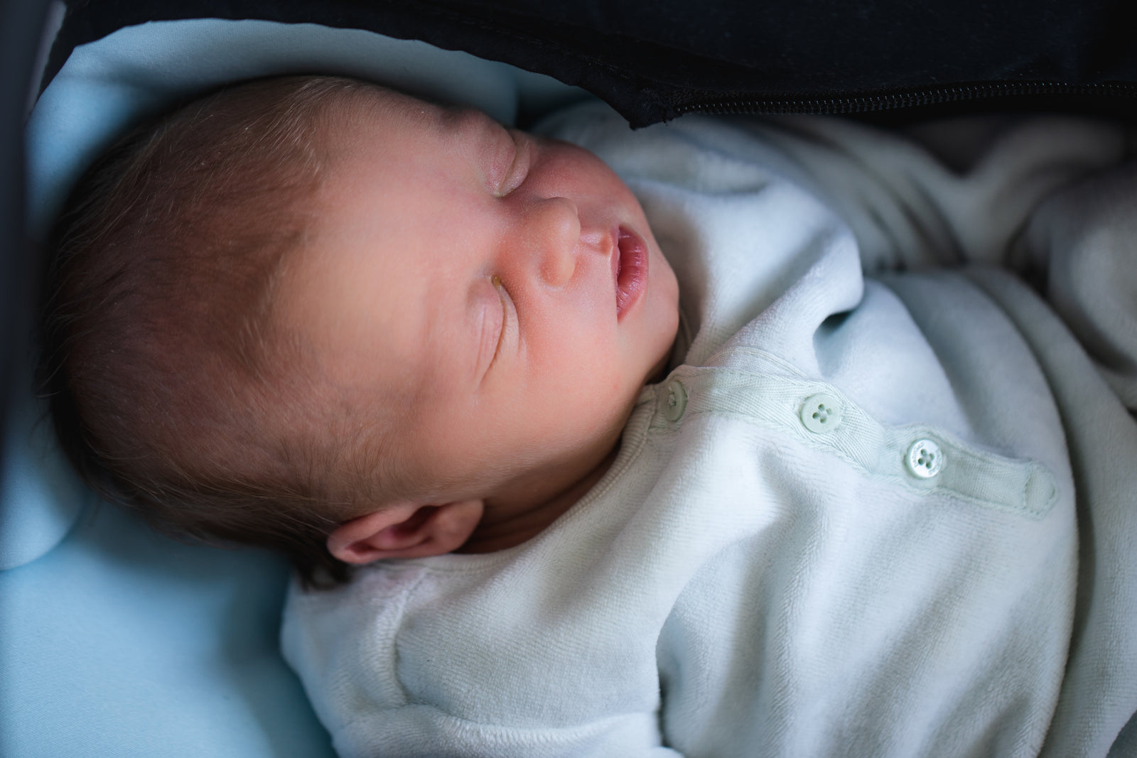 Newborn resting in soft Keebee essentials